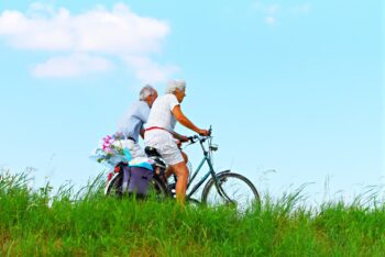 A senior couple rides bikes in one of US states that offer the best quality of life for the elderly