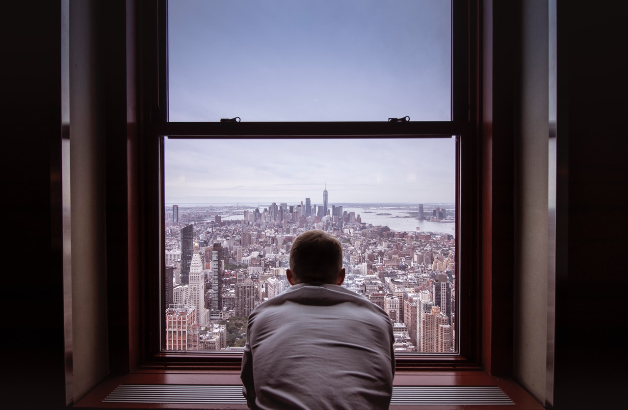 An expat looking through a window after moving to NYC