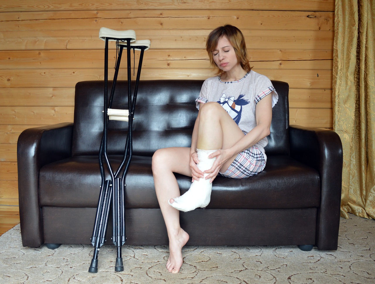 A girl with an injured ankle sitting on a couch
