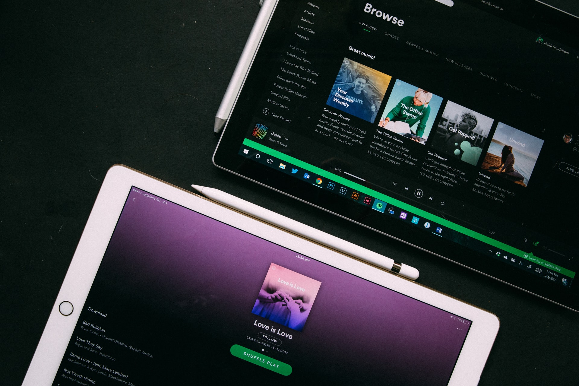 Two tables with Spotify apps opened on them